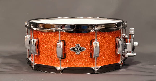 14x5.5" Liberty Drums Snare drum in a stunning orange sparkle lacquer